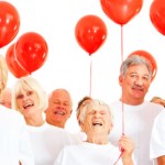 Seniors celebrating with red balloons Seniors celebrating with red balloons