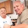 senior couple mugs in kitchen