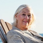 Senior woman reading book on beach Senior woman reading book on beach
