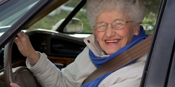 A senior woman at the wheel of her car