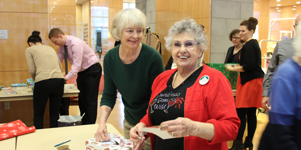 Tapestry Retirement Community Volunteers Wrapping Gifts