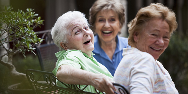 Three Elderly Woman laughing on patio